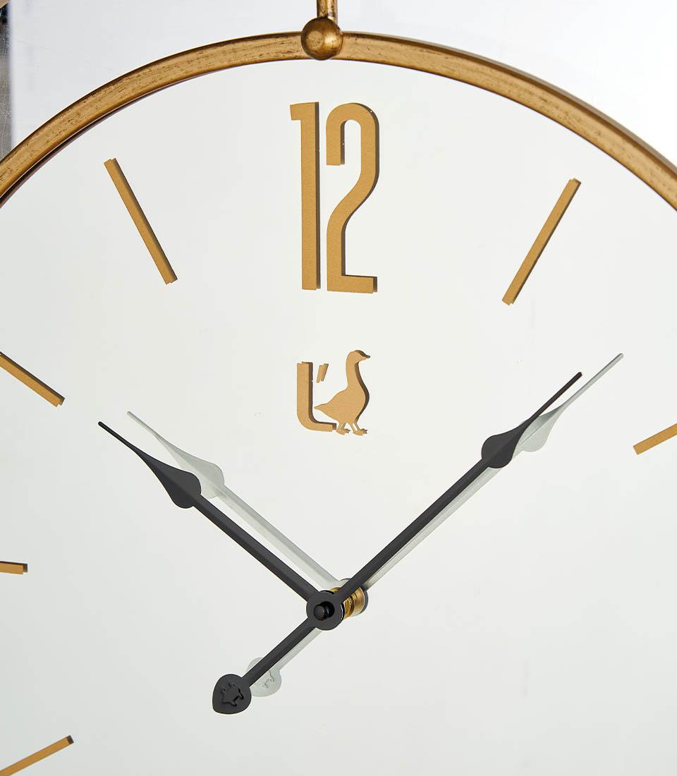 Orologio Parete specchio e metallo oro. L'oca nera